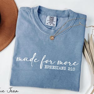 a t - shirt that says made for more ephesians 2010 next to a