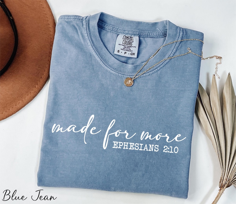a t - shirt that says made for more ephesians 2010 next to a