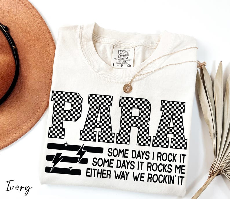 a white t-shirt with a black and white checkered design, along with a brown hat and a plant.