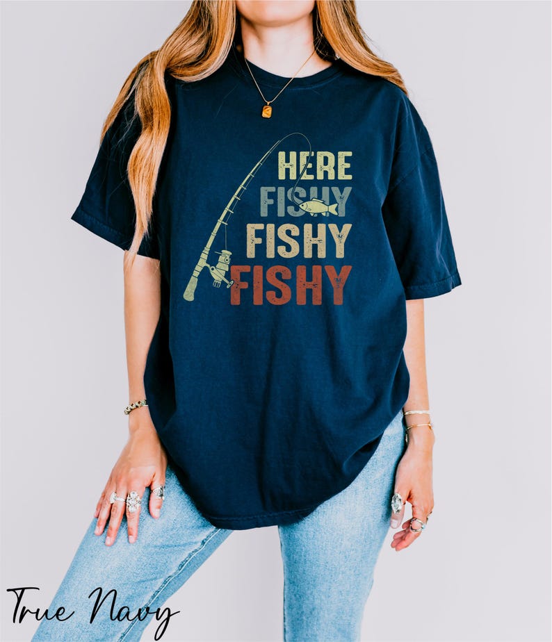 a woman wearing a t - shirt that says here fishy fishy
