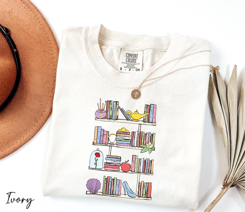 a hat, sunglasses, and a t - shirt with a picture of a book