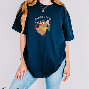 a woman wearing a t - shirt with a mouse on it