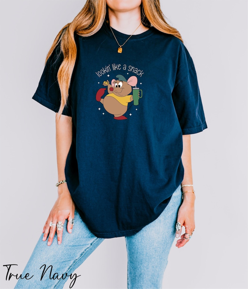 a woman wearing a t - shirt with a mouse on it