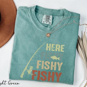 a t - shirt that says here is a fishy fishy on it