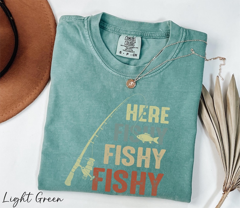 a t - shirt that says here is a fishy fishy on it