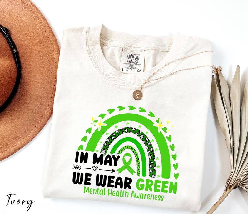 a hat, sunglasses, and t - shirt on a white surface