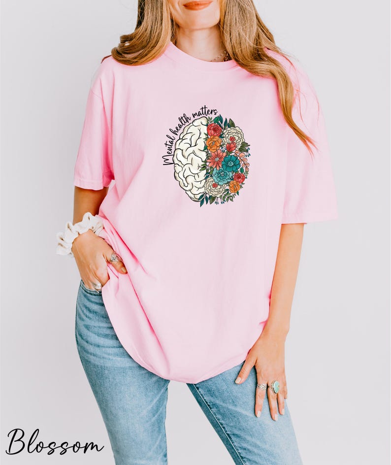a woman wearing a pink shirt and jeans