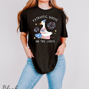 a woman wearing a patriotic goose on the loose shirt