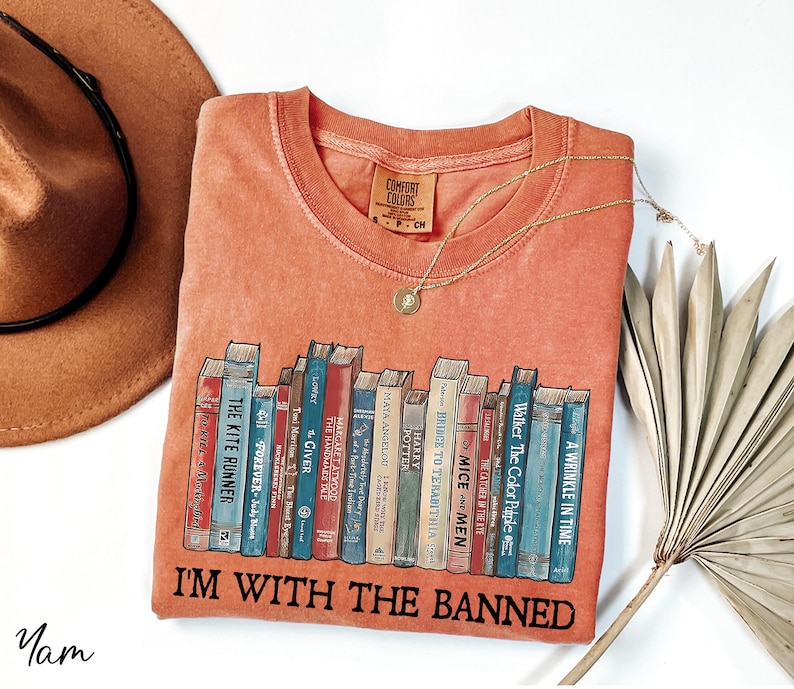 a t - shirt that says i'm with the banned on it next to