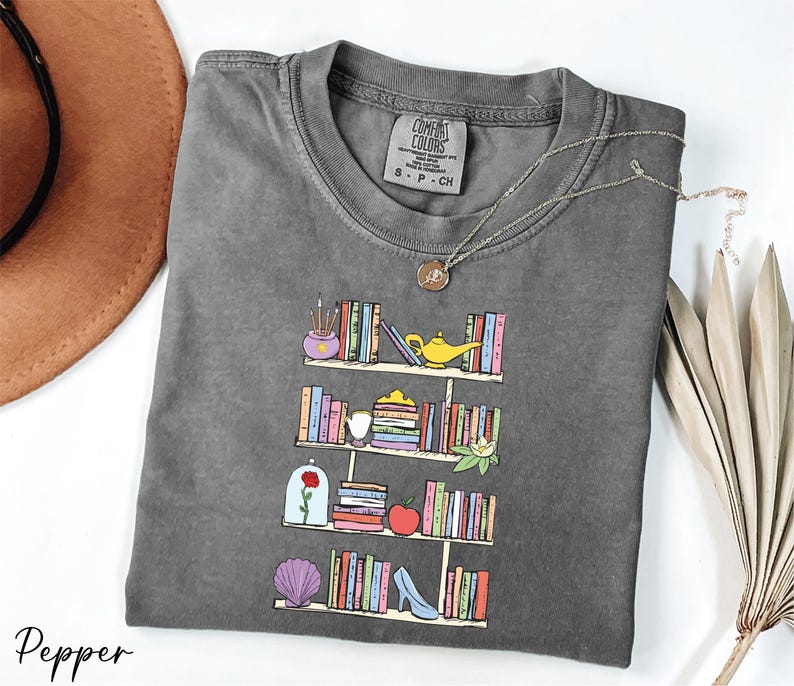 a t - shirt with a picture of a bookshelf on it