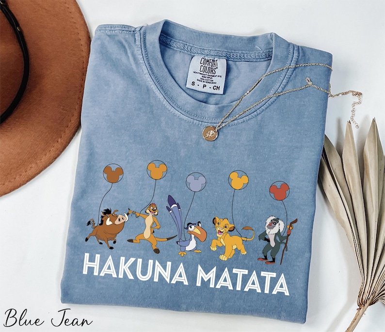 a blue tshirt with a picture of hakuna matata on it