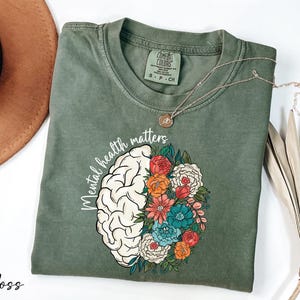 a t - shirt with a brain and flowers on it