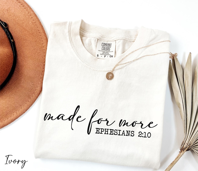 a hat, sunglasses, and t - shirt on a white surface