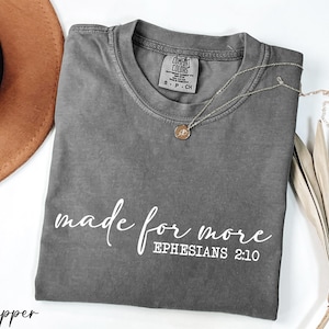 a t - shirt that says made for more ephesians 2012 next to a