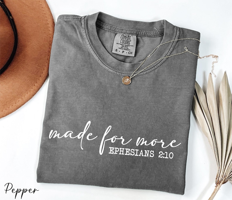 a t - shirt that says made for more ephesians 2012 next to a