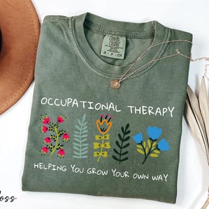 a t - shirt with a message on it and a hat next to it