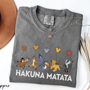 a gray tshirt with a picture of hakuna matata on it