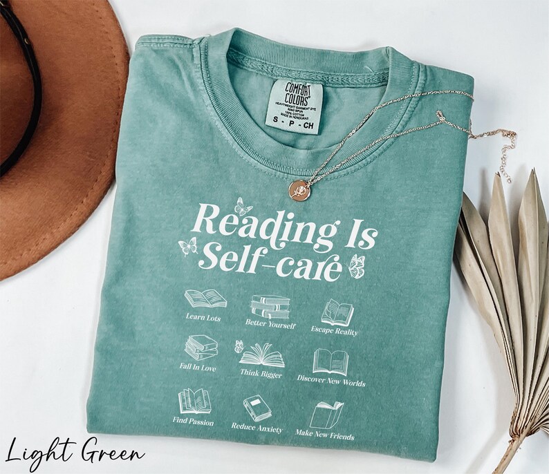 a t - shirt that reads reading is self - care