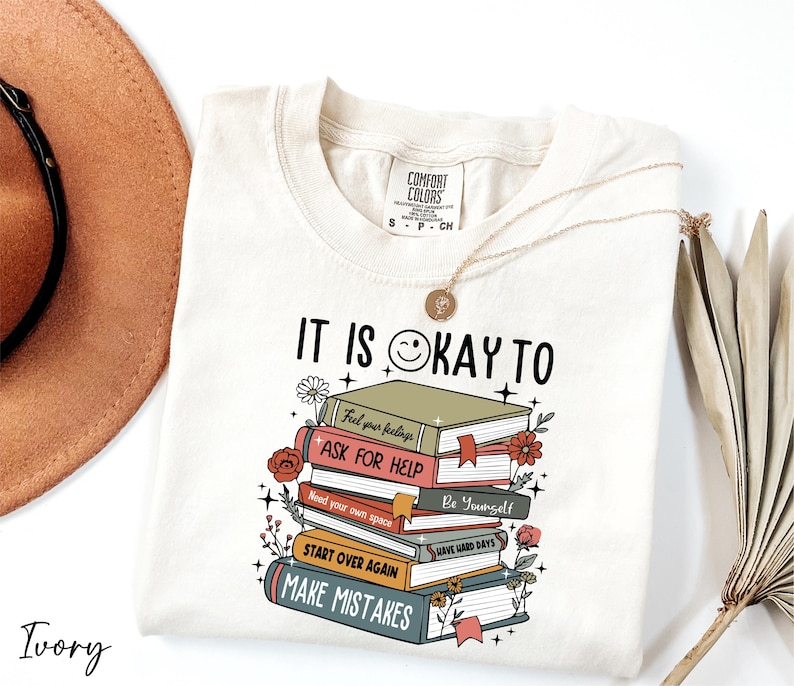 a white shirt with a stack of books on it