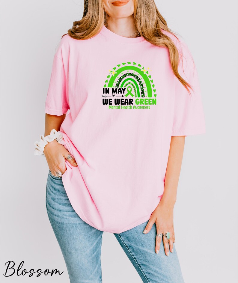 a woman wearing a pink shirt that says in may we wear green