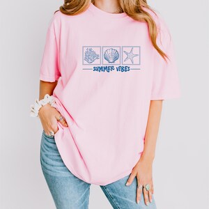 a woman wearing a pink shirt and jeans