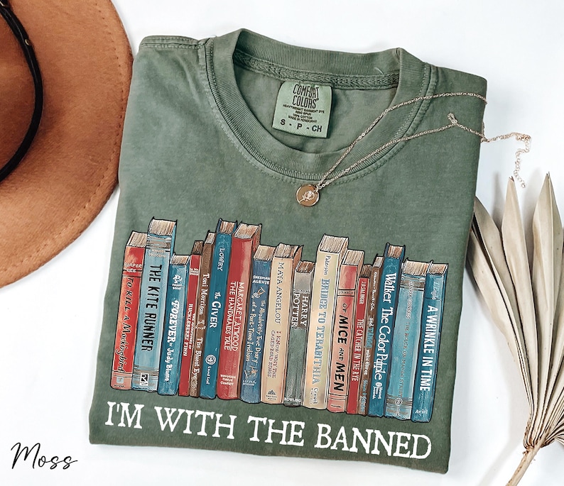 a t - shirt with a bunch of books on it