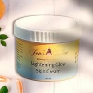 May include: A jar of Jen's Collection Lightening Glow Skin Cream. The cream is in a clear jar with a white lid. The label has a gradient of yellow to blue. The jar is 10 oz.