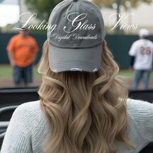 May include: A gray baseball cap with a distressed look and the text "Looking Glass Views Digital Downloads" on the front.