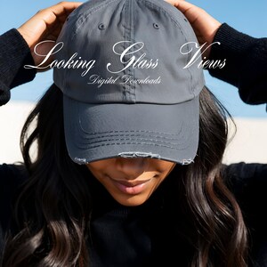 May include: A gray distressed baseball cap with the text "Looking Glass Views Digital Downloads" embroidered on the front.