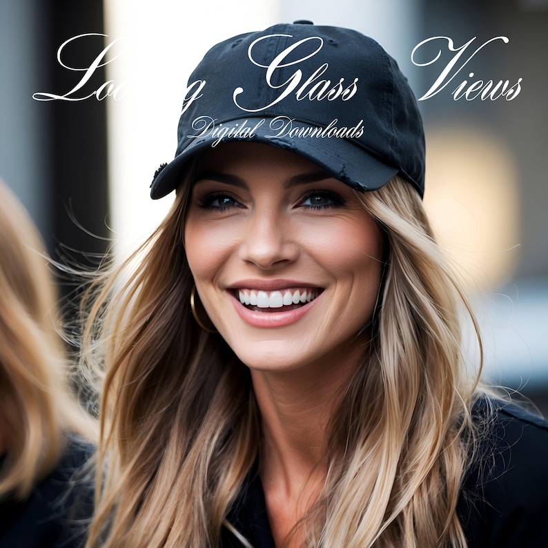 May include: A woman with long blonde hair is smiling and wearing a black baseball cap with the text "Long Glass Views Digital Downloads" on it.