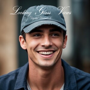 May include: A man with a friendly smile is wearing a gray baseball cap with the text "Looking Glass Views Digital Downloads" on the front. He is wearing a dark blue shirt.
