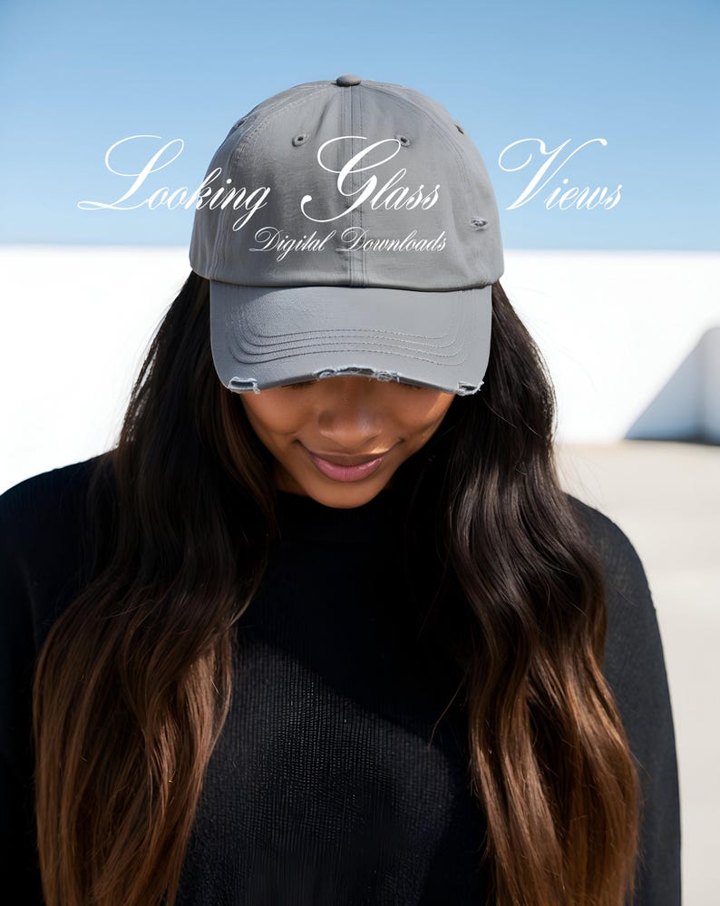 May include: A grey distressed baseball cap with the text "Looking Glass Views Digital Downloads" on the front.