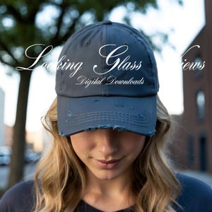 May include: A dark gray distressed baseball cap with the text "Looking Glass Digital Downloads" in white cursive lettering.