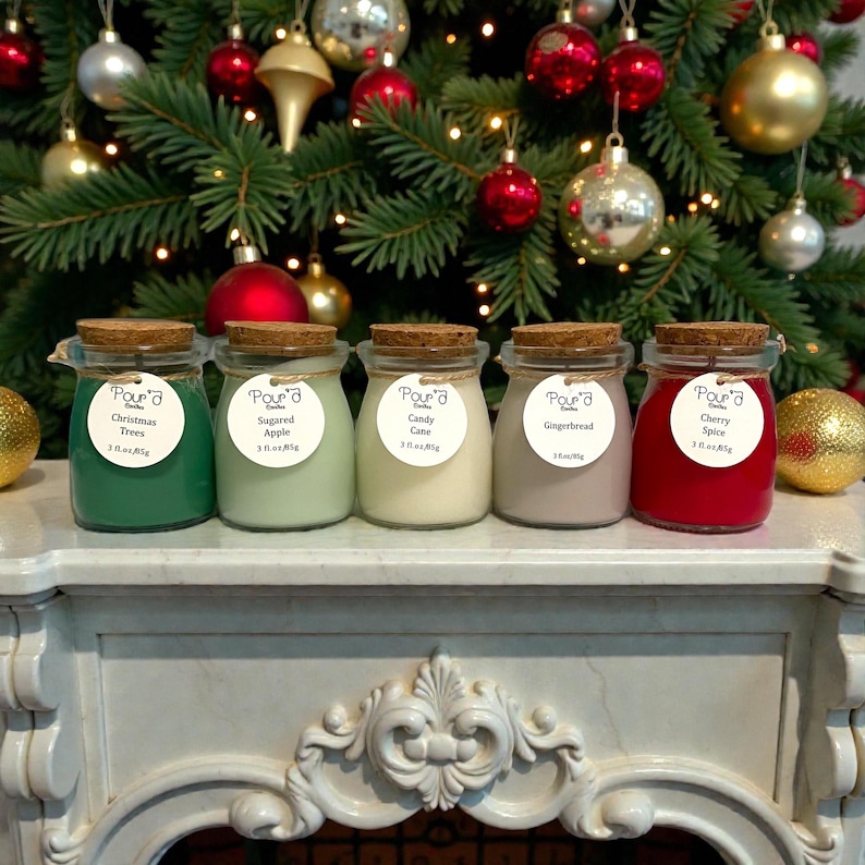 May include: Five glass jars with cork lids, each containing wax in different colors: dark green, light green, off-white, beige, and red. Each jar has a round white label with the text Pour'd Candles, a scent name, and 3 fl.oz./85g.