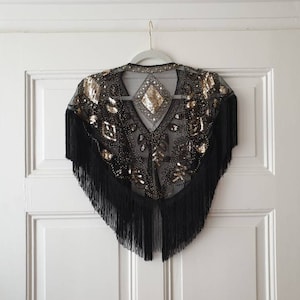 20s style dream cape "Flapper Girl" in black and gold with sequins and fringes in size. 32-40