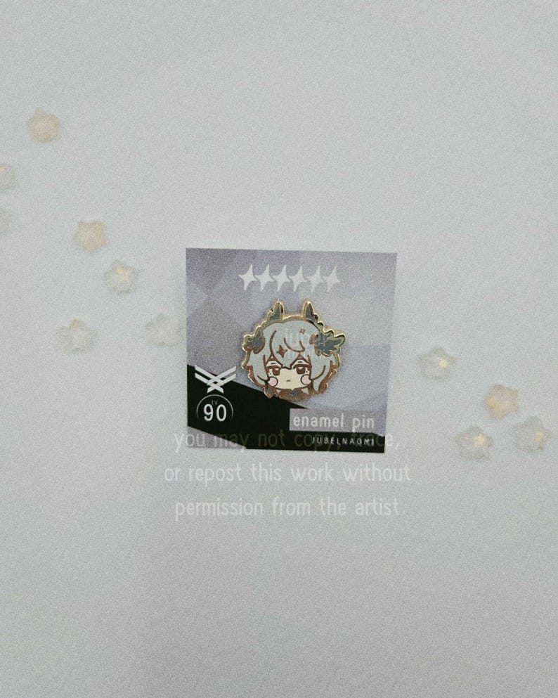 May include: An enamel pin featuring a cartoon character with light brown hair and a neutral expression. The pin is on a card with text that reads "enamel pin" and "90". The card also includes text that says "you may not or repost this work without permission from the artist."