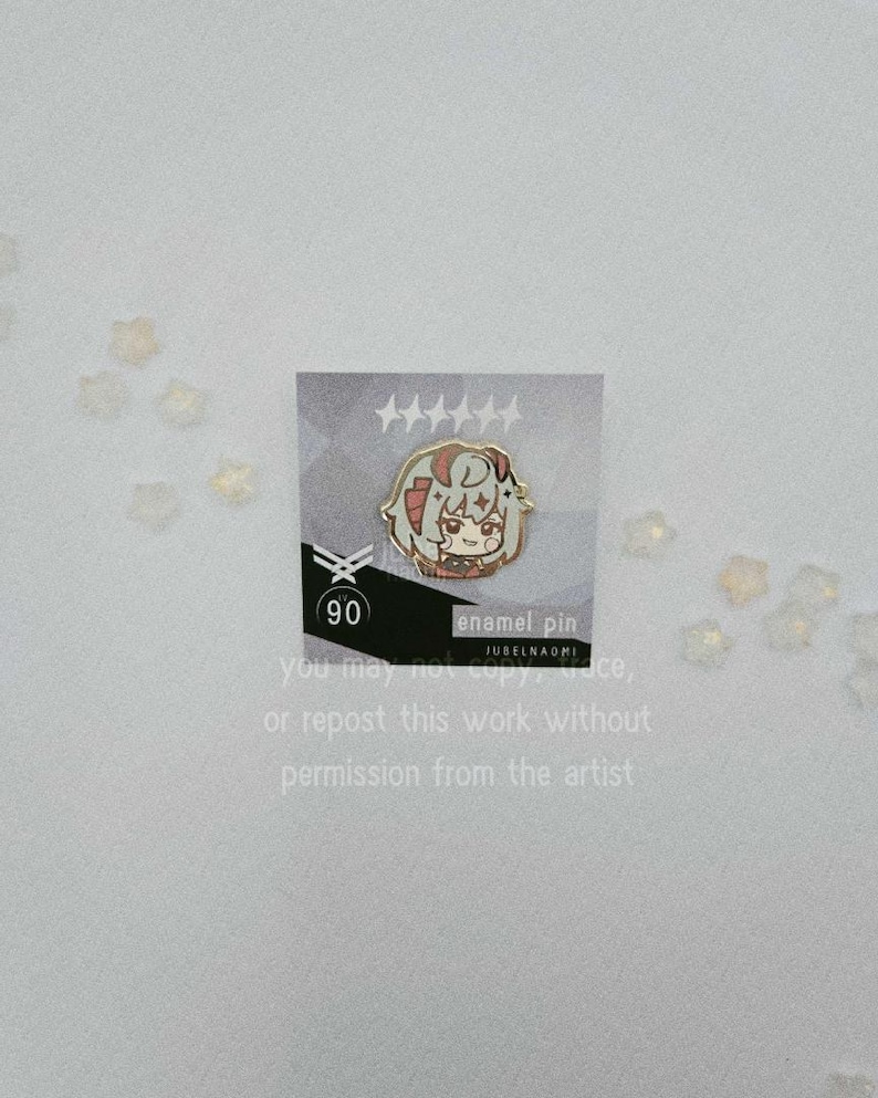 May include: An enamel pin featuring a cartoon character with red and gray hair, set against a gray and white background. The pin is on a card with text that reads "enamel pin" and "90". The card also has text that says "You may not copy, trace, or repost this work without permission from the artist."