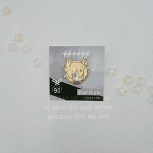 May include: A gold-colored enamel pin featuring a cartoon character with light brown hair and a black outfit. The pin is on a card with text that reads "enamel pin" and "you may not CUBELNAOMIace, or repost this work without permission from the artist."
