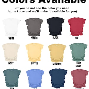 May include: A grid of twelve short-sleeved t-shirts in various colors labeled White, Pepper, Black, Red, Ivory, Butter, Mustard, Light Green, Blue Spruce, Flo Blue, True Navy, and Crimson, with the text Colors Available at the top.