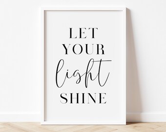 May include: White framed print with black text that reads "Let your light shine".