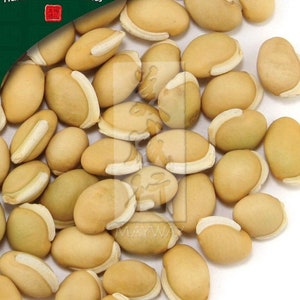 May include: A close-up image of a pile of light brown and white beans. The beans are oval-shaped and have a slightly wrinkled texture. The beans are arranged in a random pattern, with some beans overlapping others. The beans are on a white background.