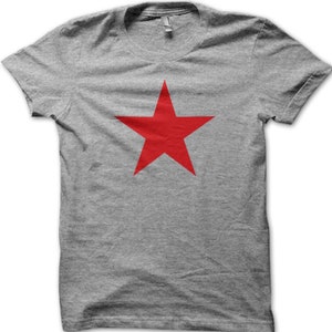 May include: A gray t-shirt with a large red five-pointed star in the center.