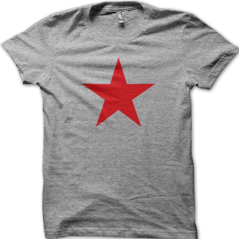 May include: A gray t-shirt with a large red five-pointed star in the center.