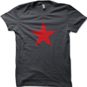 May include: A dark gray t-shirt with a large red five-pointed star in the center.