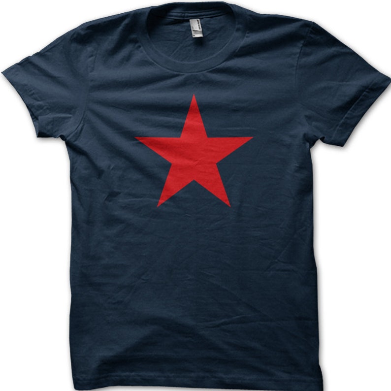 May include: A navy blue t-shirt with a large red five-pointed star in the center.