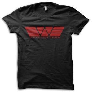 May include: Black t-shirt with a red graphic of a stylized "W" and horizontal lines, with the text "WEYLAND CORP" below. The shirt is made of a soft material and has a crew neck.