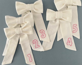 Long White Linen Birthday Bow with hand embroidered birthday number.