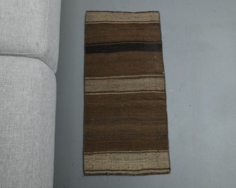May include: A brown and beige striped runner rug with a woven texture.