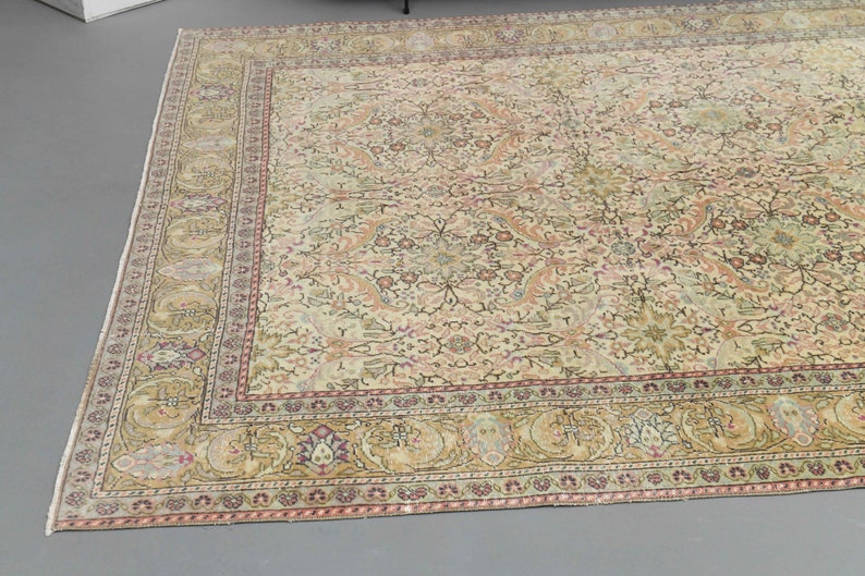 May include: A cream-colored rug with a floral pattern and a multi-colored border. The rug has a traditional Persian design.