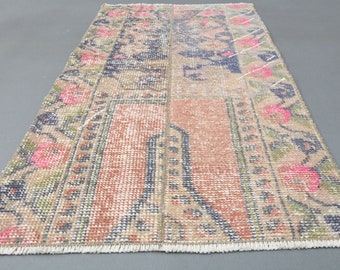 May include: A vintage Turkish rug with a patchwork design in shades of beige, pink, and blue. The rug has a fringed edge and features floral patterns.
